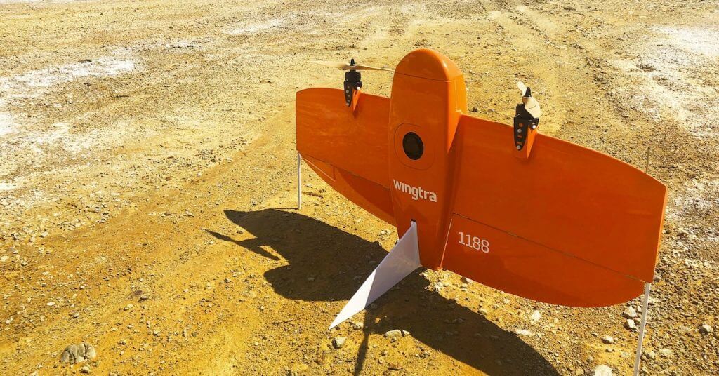 WingtraOne drone taking off on gravel terrain