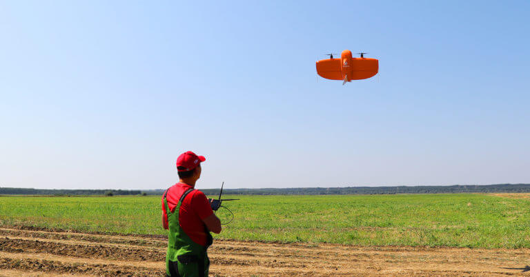 Farmer flying WingtraOne over field