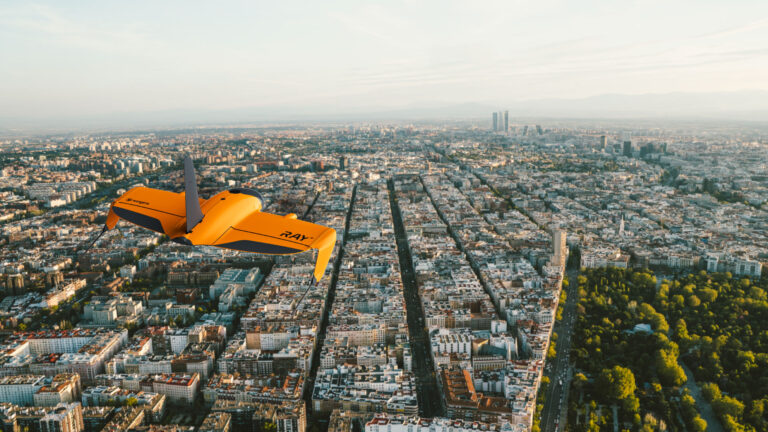 WingtraRAY surveying drone flying over a city
