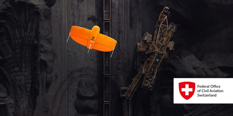 WingtraOne flying over a work site with the FOCA logo